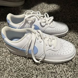 White Nike women’s shoes with light blue swoosh